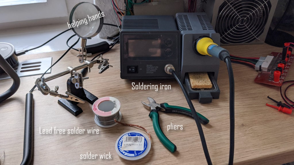 soldering station with wire, pliers and soldering wick